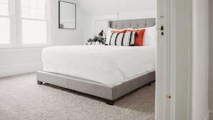 A bedroom with a bed, a headboard, a window, and a door. - Family & dog friendly; 5 min walk to beach, bars, downtown, restaurants and park (Detroit Lakes)
