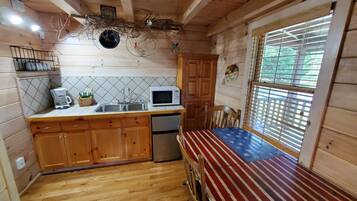 Fridge, microwave, coffee/tea maker, cookware/dishes/utensils