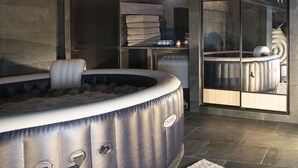 A modern bathroom with a spa tub, a glass shower enclosure, and a towel rack. - LA Maison Bordeaux: Celebrating Lifes Pleasures, the French Way (Bordeaux)