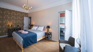 A bedroom with a bed, bedside tables, a chandelier, and a view of the outside. - LA Maison Bordeaux: Celebrating Lifes Pleasures, the French Way (Bordeaux)