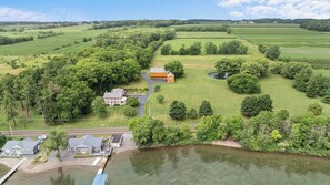 A large estate with multiple buildings, a dock, and a pond. - Olver Farm Guest House : Park-Like Setting (Romulus)