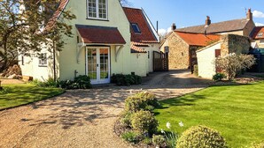A traditional house with a steeply pitched roof, a front door, and a gravel driveway leading to a grassy yard. - 3 bedroom accommodation in Hotham, near Beverley (Hotham, near Beverley)