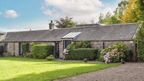 A stone building with a sloped roof, a small garden, and a gravel driveway. - You’ll love the bright open space allowing for some real family fun. (Lothianburn, near Edinburgh)