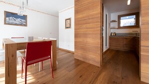 A modern kitchen with wooden cabinets and a window above the sink. - Italianway - Castellazzi 14 (Bormio)