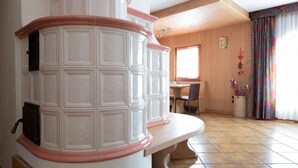 A room with a fireplace, wooden furniture, and a window with curtains. - Italianway - Funivie 6A (Bormio)