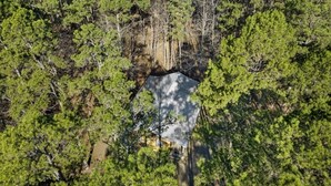An aerial view of a cabin surrounded by dense green forest. -  Secluded Hochatown Cabin w/ Hot Tub, Fire Pit - Sleeps 6 🌲 (broken bow)