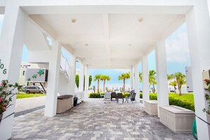 Relax in a serene outdoor space surrounded by palm trees and a clear sky.