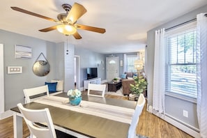 Enjoy meals in this spacious dining area with a long table and comfortable seating.