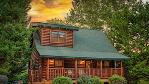 A log cabin with a porch, a small window, and a sign indicating it is a lodge. - Mtn Cabin with Hot Tub, pool table, arcade, smartTVs, fast FiWi, great location! (Pigeon Forge)