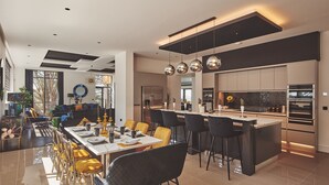 A modern kitchen with a central island, stainless steel appliances, and pendant lighting. - Reservoir View -  a modern home that sleeps 8 guests  in 4 bedrooms (Cheddar)