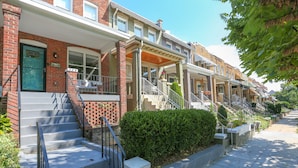 A row of townhouses with front porches, steps, and a brick facade. - Private Patio + Parking + Near H Street & DC Attractions  Great for Families! (Washington)