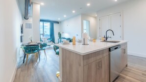 A modern kitchen with a central island, wooden cabinets, and a dishwasher. - Emerald Escape with Free Parking & 2 baths. 5 beds+Sleeps 8!  ✨20% OFF 7 days✨ (East Orange)