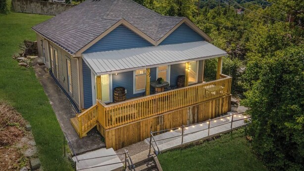 A two-story house with a wooden deck and a covered porch. - This house is a 2 bedroom(s), 1 bathrooms, located in Frankfort, KY. (Frankfort)