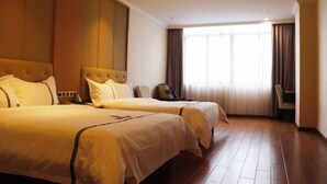 A hotel room with two beds, a large window with curtains, and a wooden floor. - Fuhe Hotel (Guangzhou)