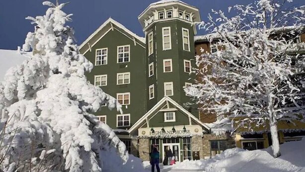A snow-covered building with a sign reading "Highland House."