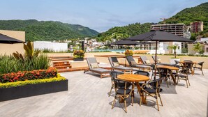 Outdoor dining - 2 Rooftop Pools! Centre of the Romantic Zone! Huge 1 Bedroom! (Puerto Vallarta)