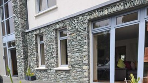 A building with stone facade and large windows.