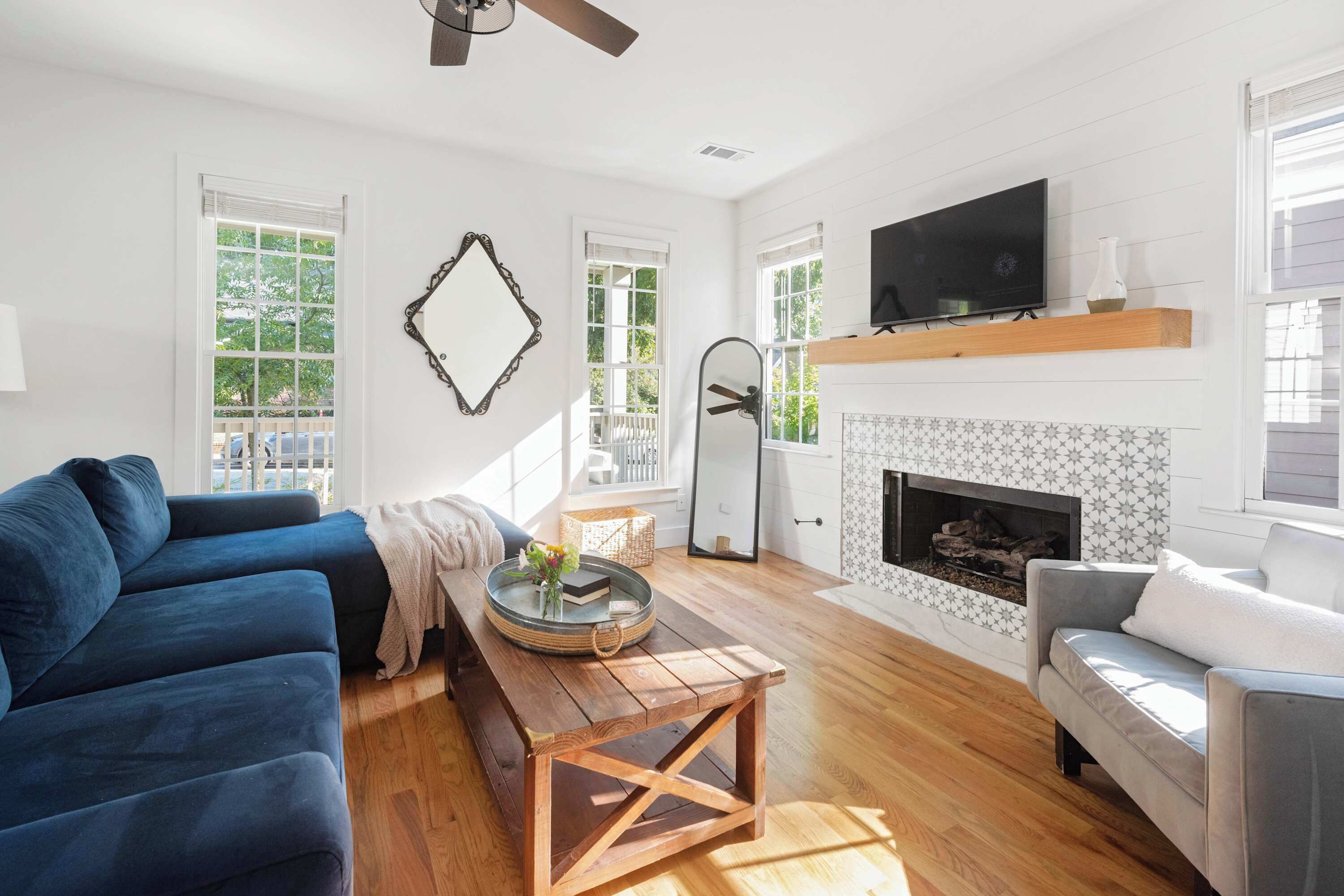 A living room with a fireplace, a TV, and a sofa.