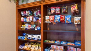 A snack display with various brands and types of snacks. - King Suite | Free Wi-Fi + Breakfast, Pool, Gym. (Lake Forest)