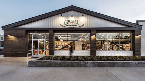 A modern building with a sign reading "Grant Park Markets".