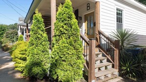 A house with a wooden staircase leading to a front door marked with a 'B'. - Whiskey Neat (Atlanta)