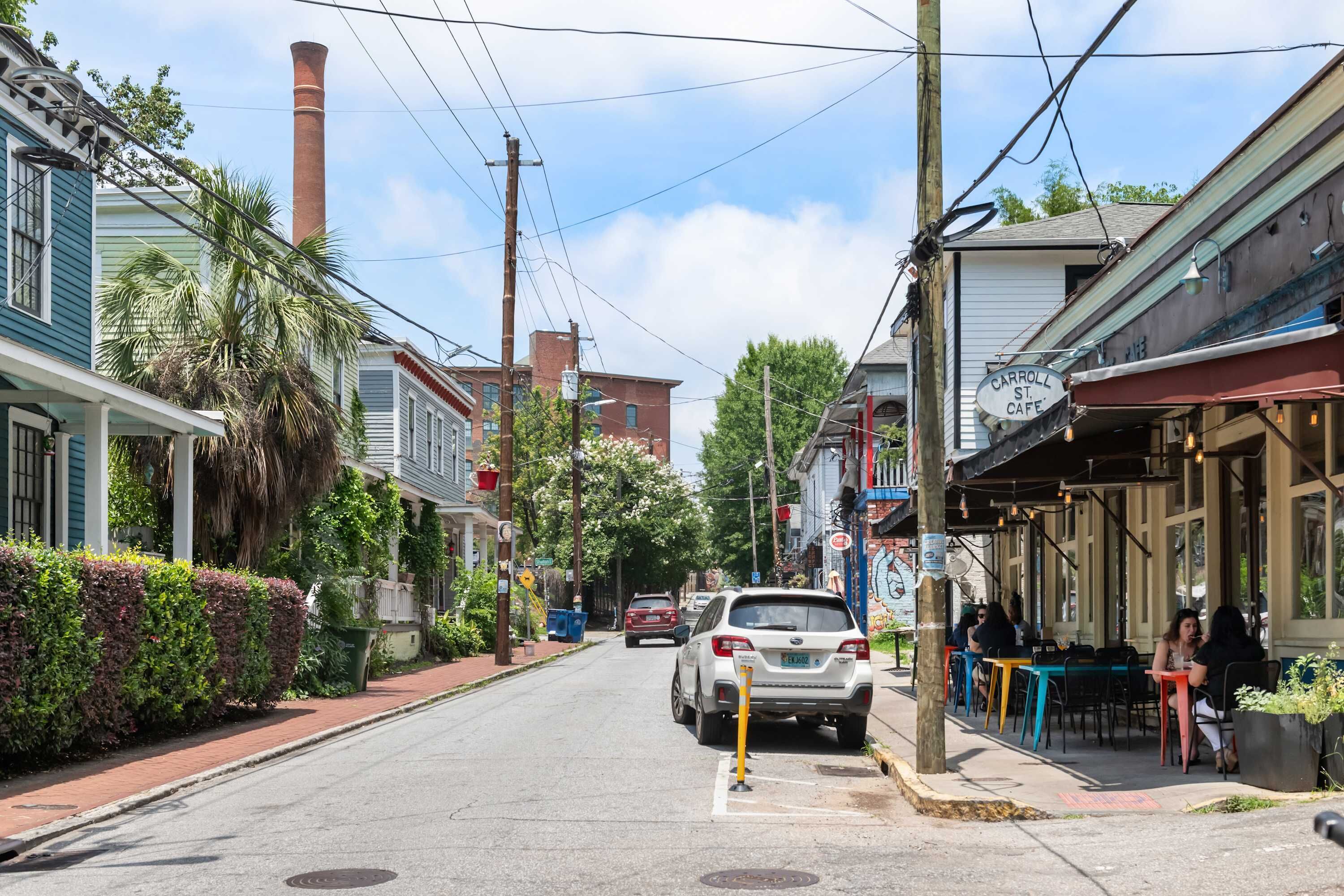 A street view with a restaurant named 'Carroll St. Cafe' and a parked car.