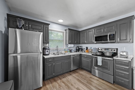 Fridge, microwave, oven, stovetop. Clean, spacious, and fully renovated townhouse with modern charm and comfort.