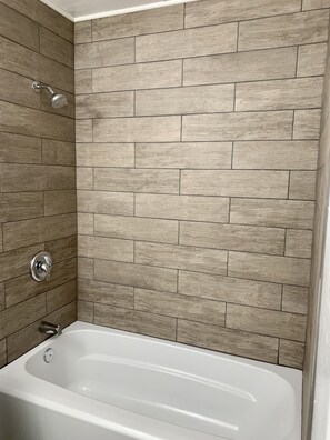 Bathtub, hair dryer, towels, soap