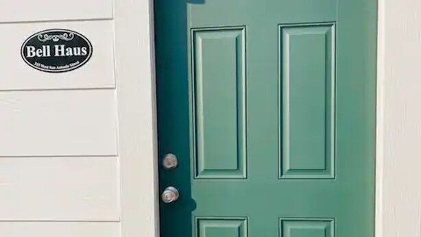 A teal door with a 'Bell Haus' sign above it. - Bell Haus-Private Hot Tub, 1/1, 100 yds to Main St (Fredericksburg)