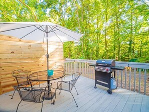 Enjoy al fresco dining and cooking on this outdoor deck with a barbecue grill and comfortable seating for four.