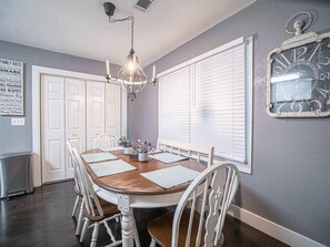 Enjoy meals in this cozy dining area with a round table and comfortable seating for all.