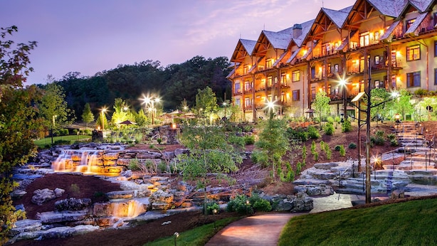 A multi-story hotel with a stone waterfall feature in the foreground. - Feb 10th-17th - Beautiful Lodge, Scenic Views, Family Friendly (Ridgedale)