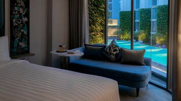 Deluxe Pool View | Premium bedding, in-room safe, desk, iron/ironing board