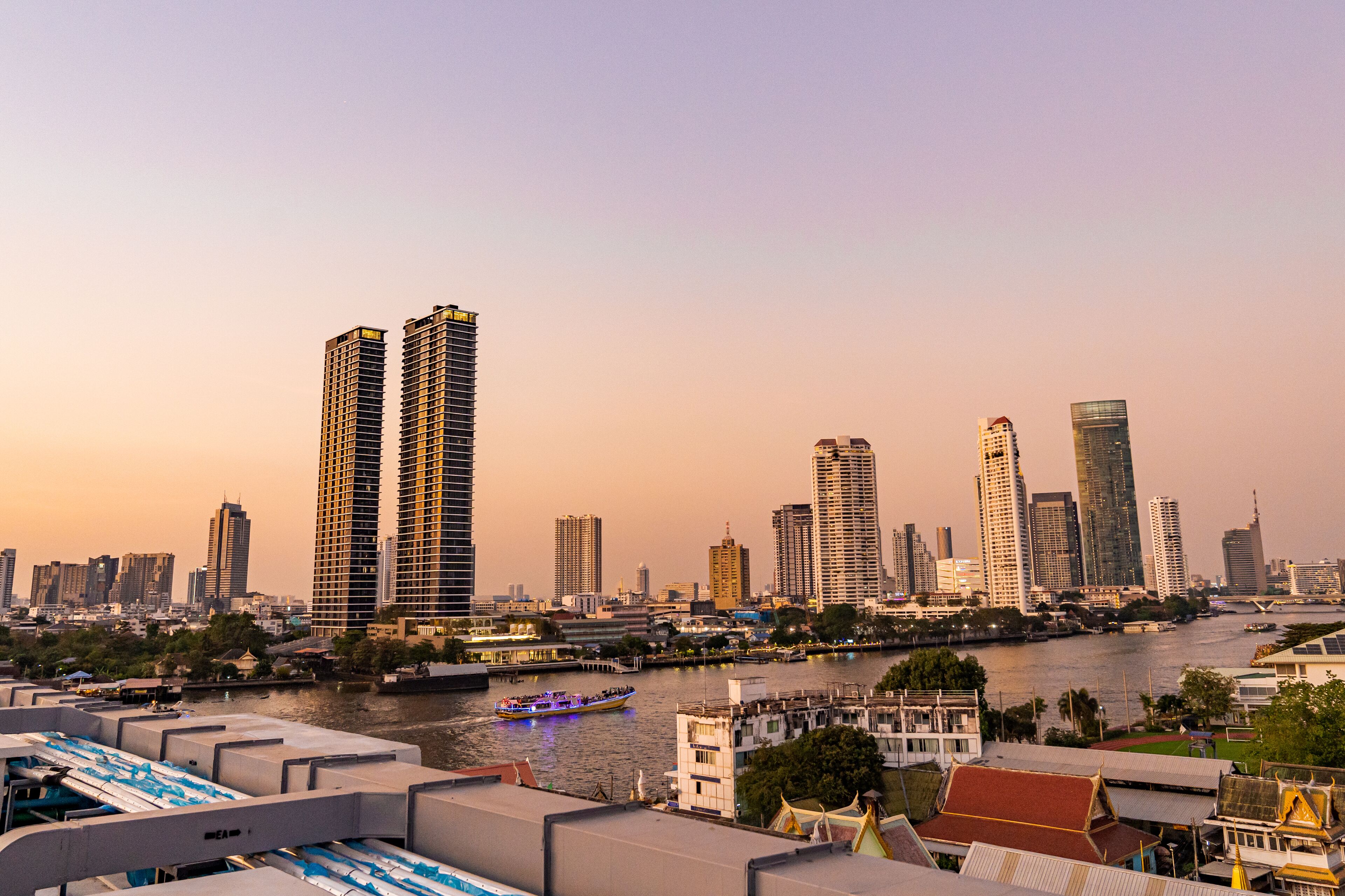 A cityscape with high-rise buildings and a river.