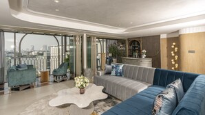 A modern living room with a sofa, armchairs, and a coffee table. - The Salil Hotel Riverside Bangkok (Bangkok)