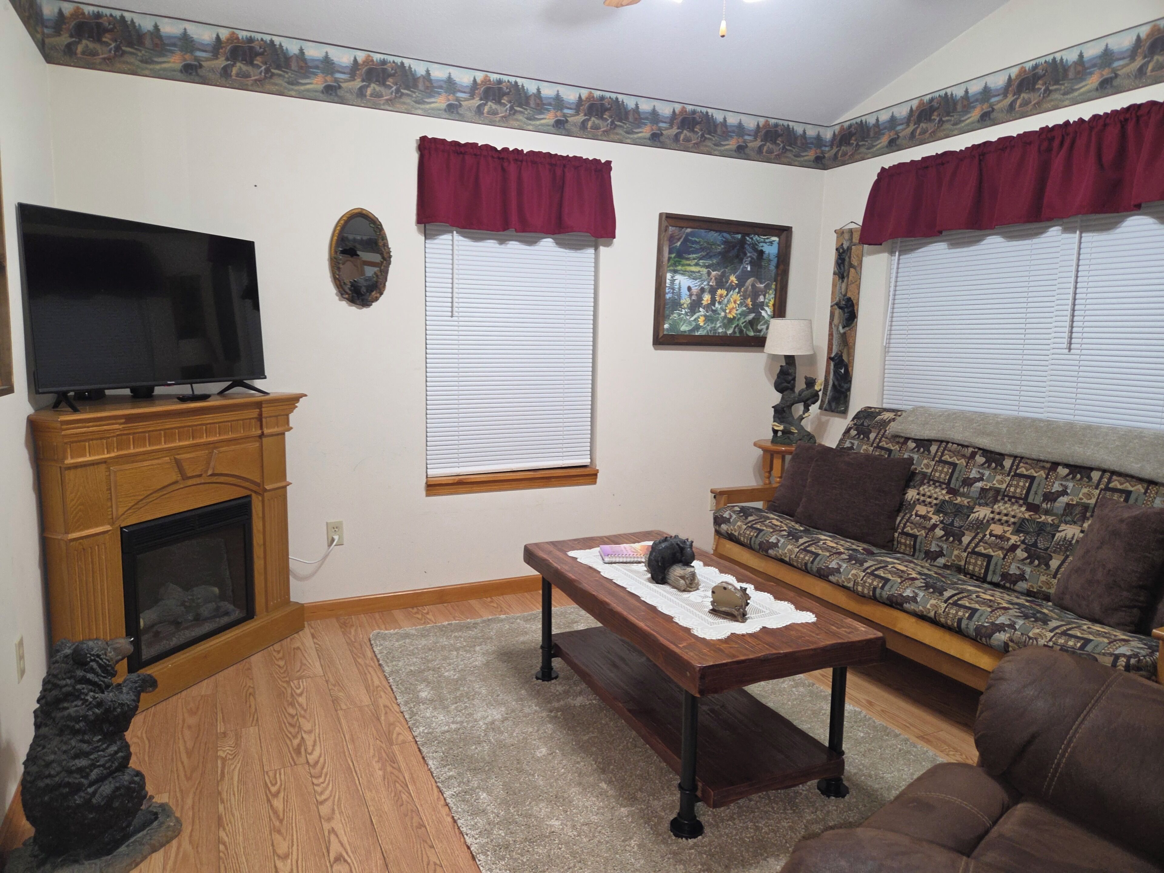 A living room with a fireplace, a television, a sofa, and a coffee table.