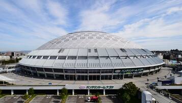 A large, modern stadium with a dome roof and multiple levels of seating.
