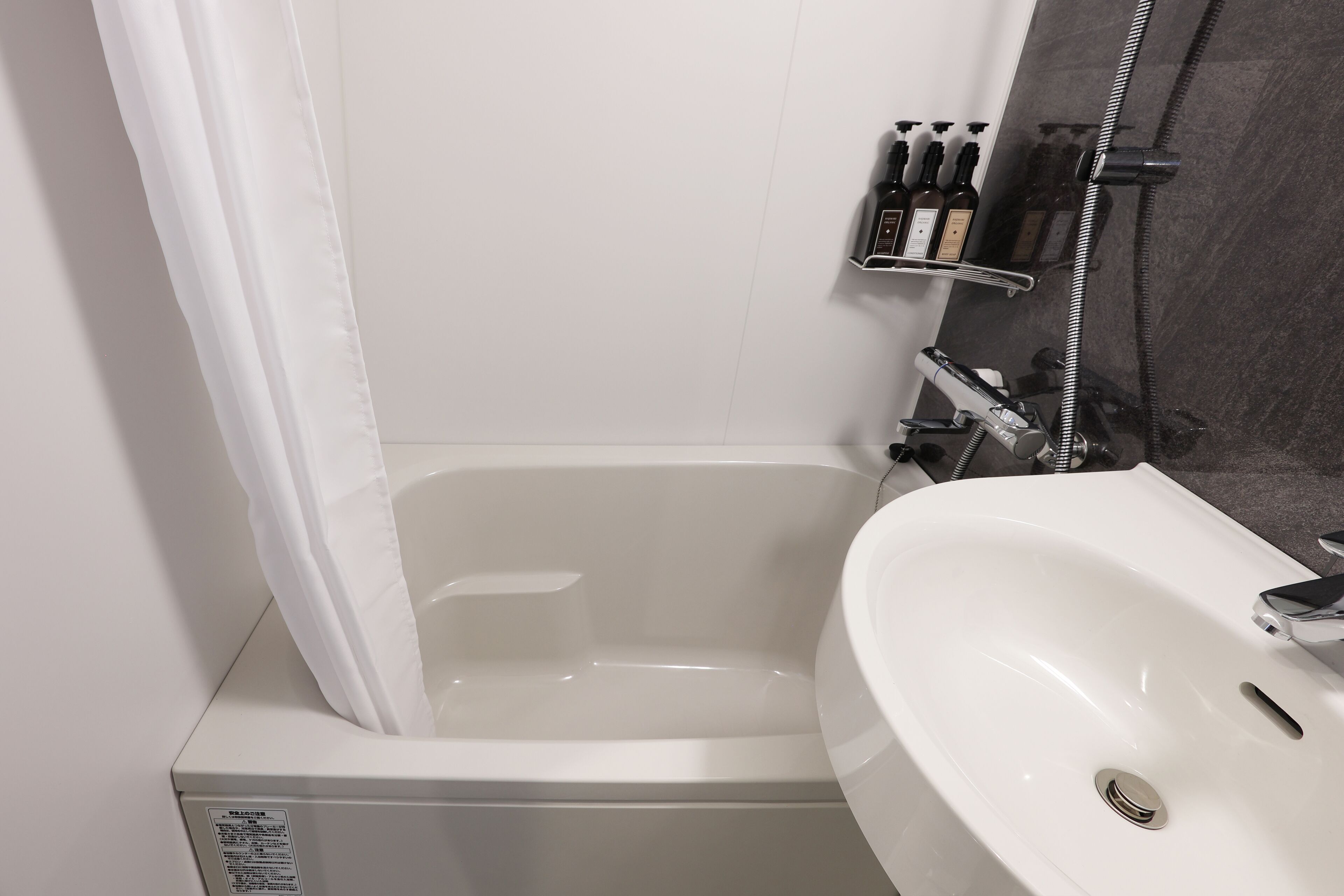 A bathroom with a bathtub, a sink, and a shower.