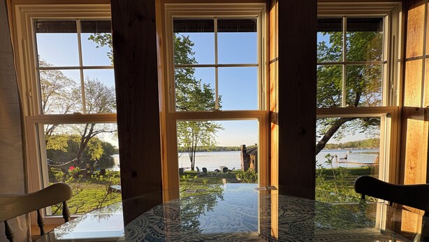 A room with large windows, a glass table, and wooden chairs. - Waterfront Cabin w/ Dock Access, Fishing & Kayaks
Beach Retreat - Cabin 3 (South Haven)