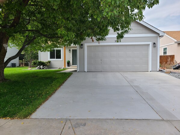 A residential garage with a driveway leading to a house. - Newly remodeled home with game room, minutes from downtown Loveland (Loveland)