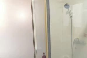 A glass shower enclosure with a handheld showerhead. - Yongsheng Business Hotel (Jiangmen)
