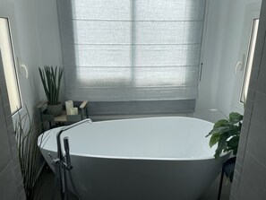 Bathtub, hair dryer, towels, soap