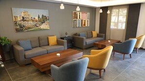 A modern living room with a sofa set, armchairs, and a coffee table. - byblos palms hotel (Blat)