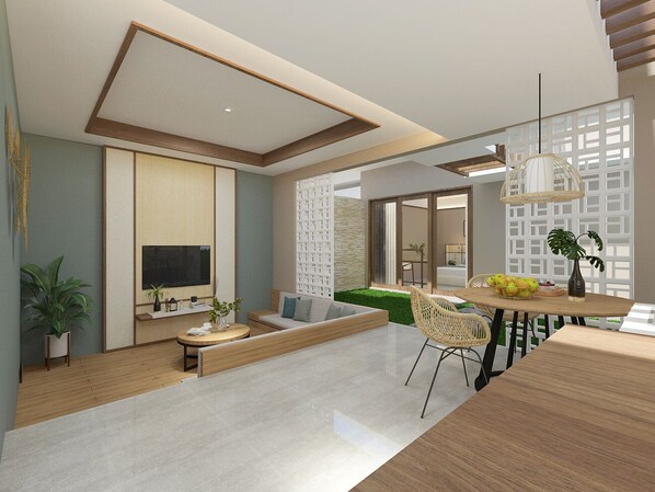 A modern living room with a sofa, coffee table, and dining area. - The Allure Villas Managed by Sahid (Pangandaran)
