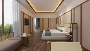 Une chambre moderne avec un grand lit, un canapé, une petite table et une vue sur la verdure.