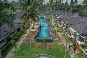 A resort with multiple villas, a central swimming pool, and lush greenery. - The Allure Villas Managed by Sahid (Pangandaran)