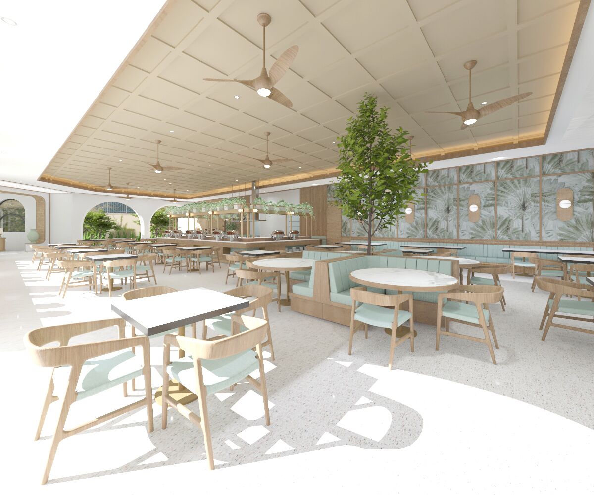 A spacious indoor dining area with multiple tables and booths, ceiling fans, and a large window providing natural light.