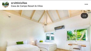 A bedroom with two beds, a desk, and a window with a view of greenery. - Snrvittinivillas Mng Spacius and Best Loc in Casa de Campo Resorts Gr8 Villa (La Romana)