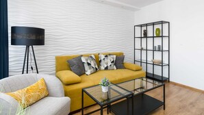 A modern living room with a sofa, armchair, and a coffee table.