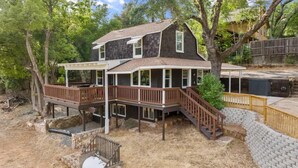 A two-story house with a deck and a covered patio area.